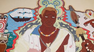 Portrait of 19th-century enslaved man Squire intricately wrought in tiny beads, with broken chains, a spear, and a ship.