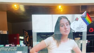 Alana Haim in ‘Licorice Pizza’ as a cardboard cutout at a movie theater concession and ticket stand
