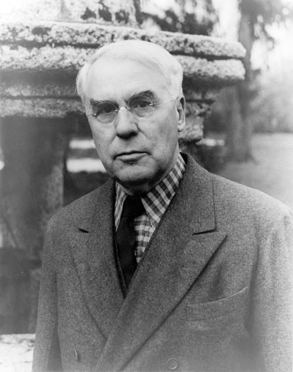 Vintage black & white photo of Albert Barnes taken in 1940. He poses in a suit coat with a serious expression.