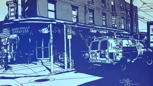 An image of a street corner by the South Philly Barbacoa storefront, a parked van with graffiti, and muted colors and space