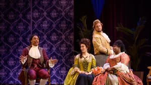 In opulent 17th-century Parisian clothes, the ensemble sits listening to Walker sing, each with different goofy expressions