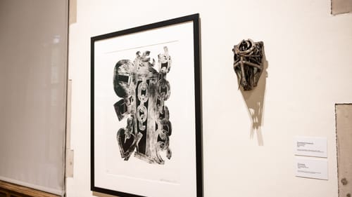 Both pieces, described in the article text above, hang next to each other on a white gallery wall.