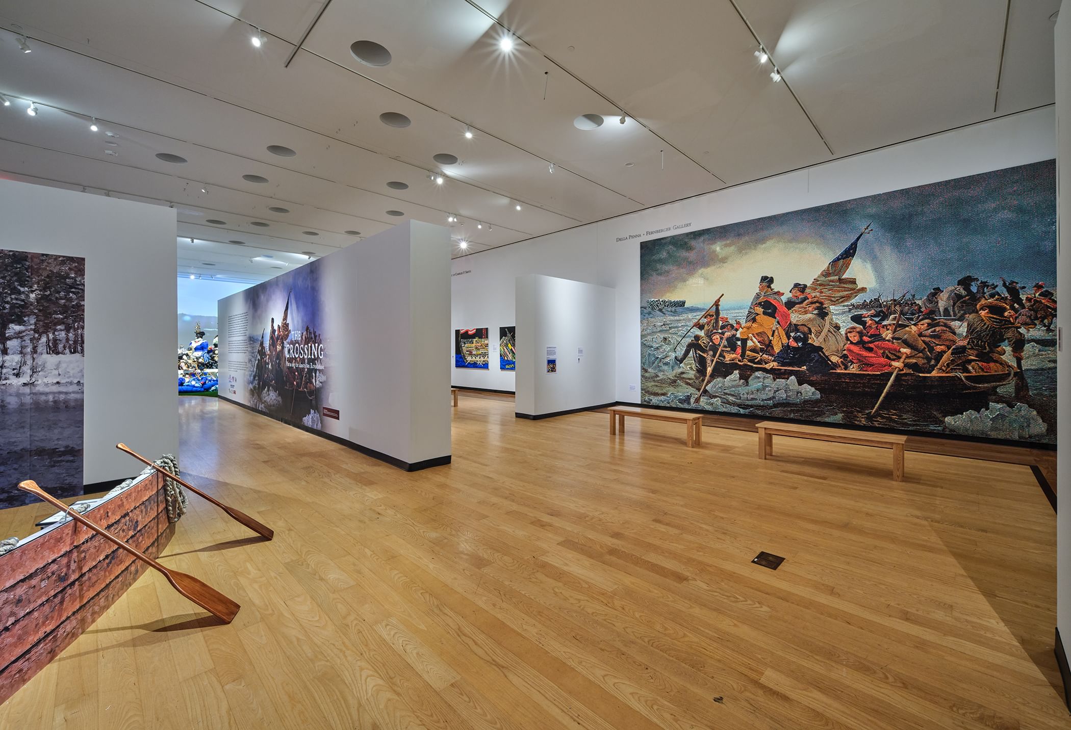 A large gallery with white-walled segments, a large recreation of the famous painting of Washington on the Delaware at right.