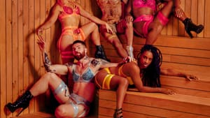 5 actors of different genders, wearing colorful lingerie & high-heel boots, pose sensually together in the corner of a sauna