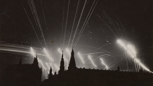 Stark black & white photo of silhouetted spired buildings at bottom, with bright flares shooting upward into a black sky.