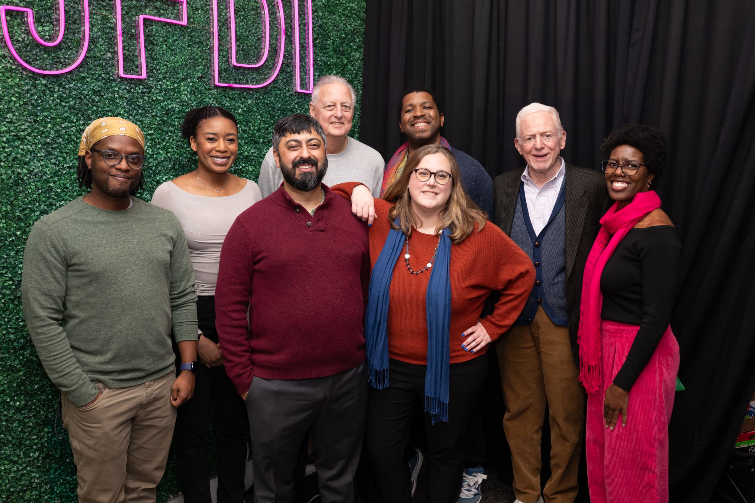 The BSR crew poses smiling together in a corner of the anniversary party venue.