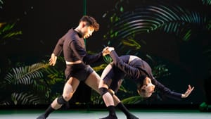 In a wide, dynamic stance, Joubert holds Lubin by the hand as she dips backwards into an almost impossible full-body curve.