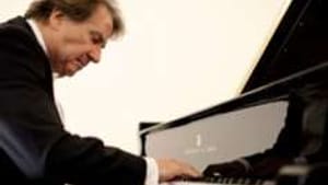 While Buchbinder played, the real drama unfolded below him.