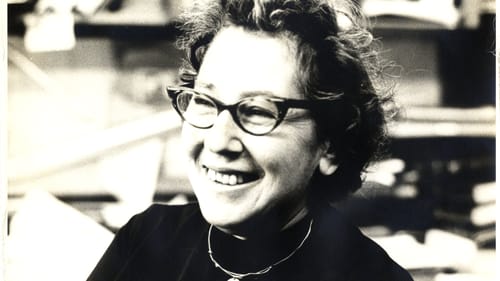 Cohn, shown in middle age in a black & white photo, smiling with short curly hair and horn-rimmed glasses.