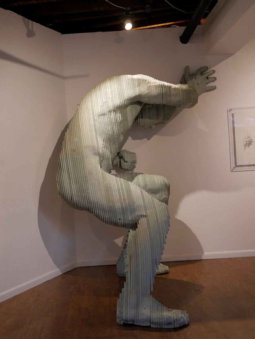 A large-format Styrofoam sculpture layered with sheets of foam holds up the gallery wall. (Photo courtesy of RACSO Art Gallery.)