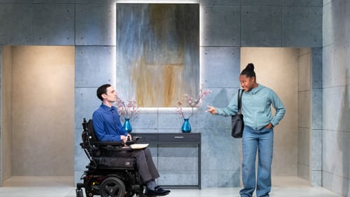 Prentice, a white man in a power wheelchair, faces Castro, a Black woman gesturing toward him with an anxious expression.