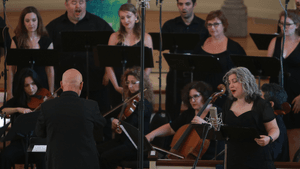 Donald Nally leads the choir, orchestra, and soloists through two renditions of Crane's poem. (Photo by Luke Carpenter.)