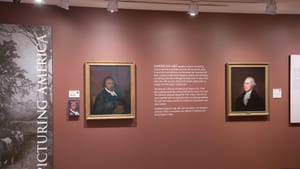 A gallery view. 18th-century paintings of Absalom Jones at left & George Washington at right. They’re the same size & shape