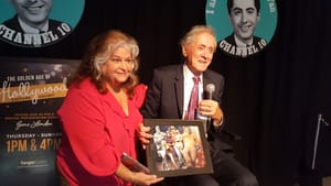 Gene London sits with recording artist and performer Denise Montana. (Photo by the author, Suzanne Cloud)