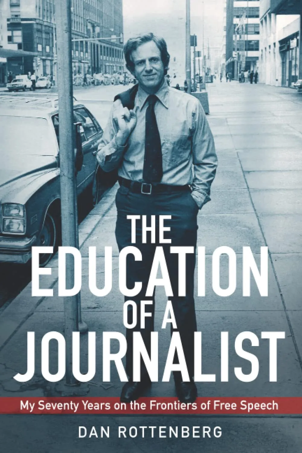 Book cover. The title and author appear in white, over a black & white photo of a young Dan Rottenberg on a city street.