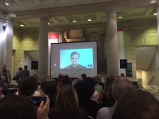 Appropriately, Snowden appears onscreen on a screen at the Free Library. (Photo by Sarah Grey.)
