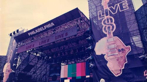 Photo of the giant outdoor stage structure, with huge Live 8 logos on either side featuring guitars in the shape of Africa.