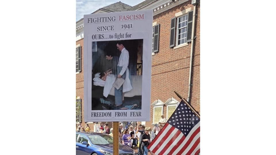 Closeup on a sign reading “Fighting fascism since 1941. OURS to fight for…FREEDOM FROM FEAR” with a famous Rockwell painting