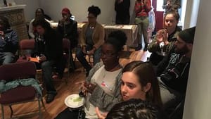 An audience in Blouin's living room applauds a SoLow Festival performance. (Photo by Cara Blouin.)