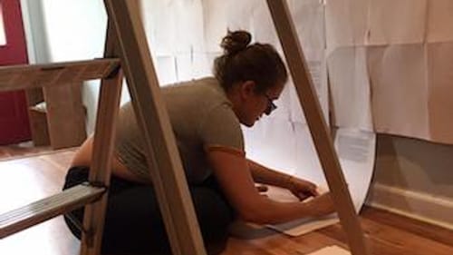 Tenara Calem prepares the set (in Blouin's home) for her solo performance piece 'Me, More Normal.' (Photo by Cara Blouin)