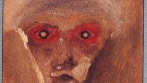 A painting with reds and browns that roughly reveal a face; eyes, nose, and mouth more apparent, the rest are soft lines