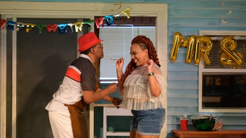 Looking delighted with each other, Smiling and Hammond, who wears a sheer fringed top & denim shorts, share a bite of food