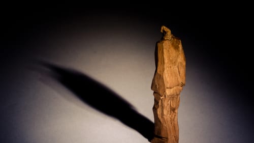 An unknown sculptor created this statue of a prisoner inside Auschwitz between 1940 and 1945. (Image courtesy of Auschwitz-Birkenau State Museum.)