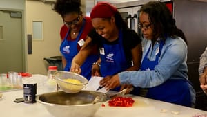 Students from Food Moxie’s after-school cooking club demonstrate how to make a roasted-sweet-potato salad and eat healthily on a budget. (Photo by Brittany Barbato.)