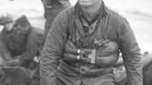 U.S. soldiers recover remains of comrades at Omaha Beach: War is always a mess.