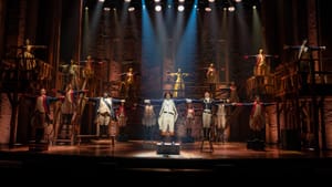 In bright spotlights, Weavers stands center stage, arms outstretched. The company mirrors his pose on the two-level set