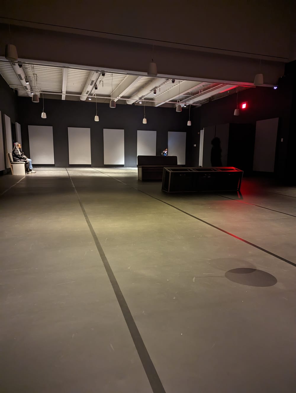 Gallery view: looking toward the end of a large room, set up as Mason describes in the text. Two people are sitting there.