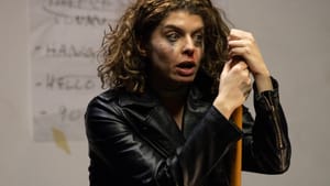 Knittel, looking distraught with makeup smeared on her face, wears a leather jacket and appears to lean on a broomstick.