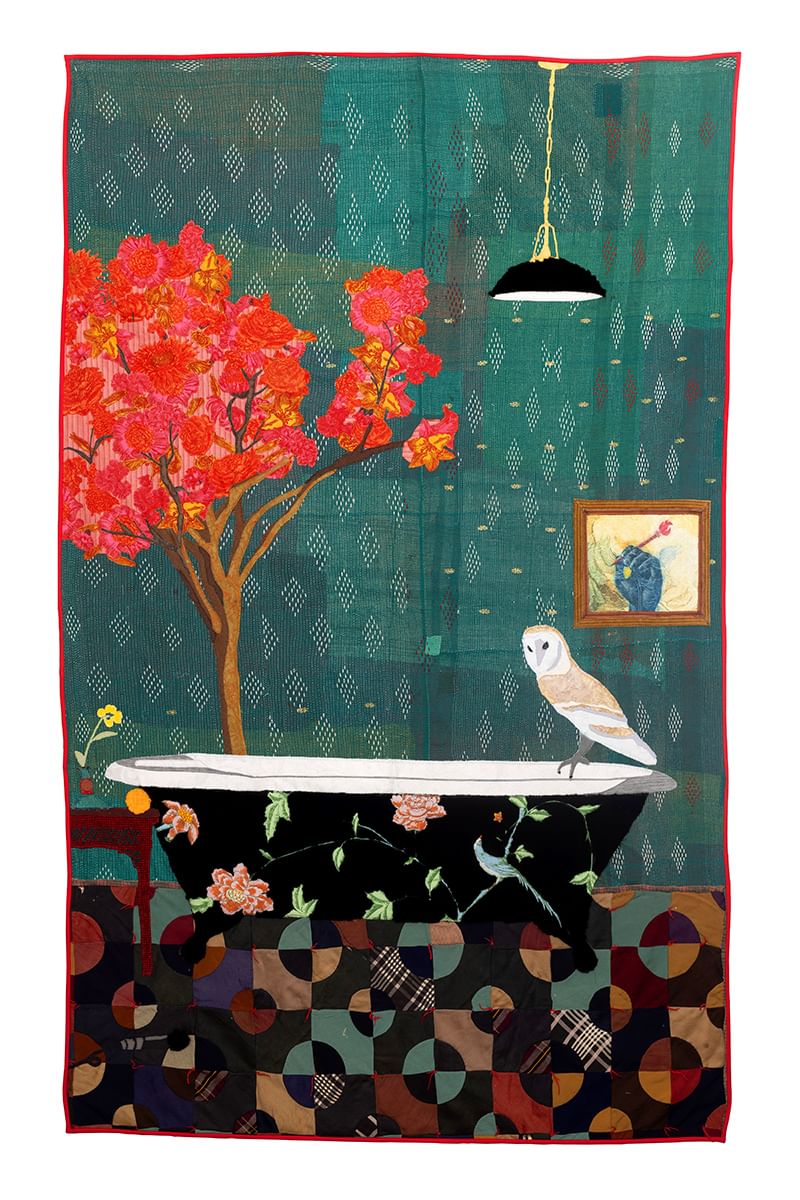 Quilt with dark, flower-patterned bathtub, a barn owl perched on the rim, next to a tree w/ red leaves on a green background