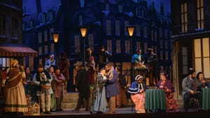 Palmertree & Graves embrace lovingly with 17 ensemble members in luxe early Victorian costumes moving around them.
