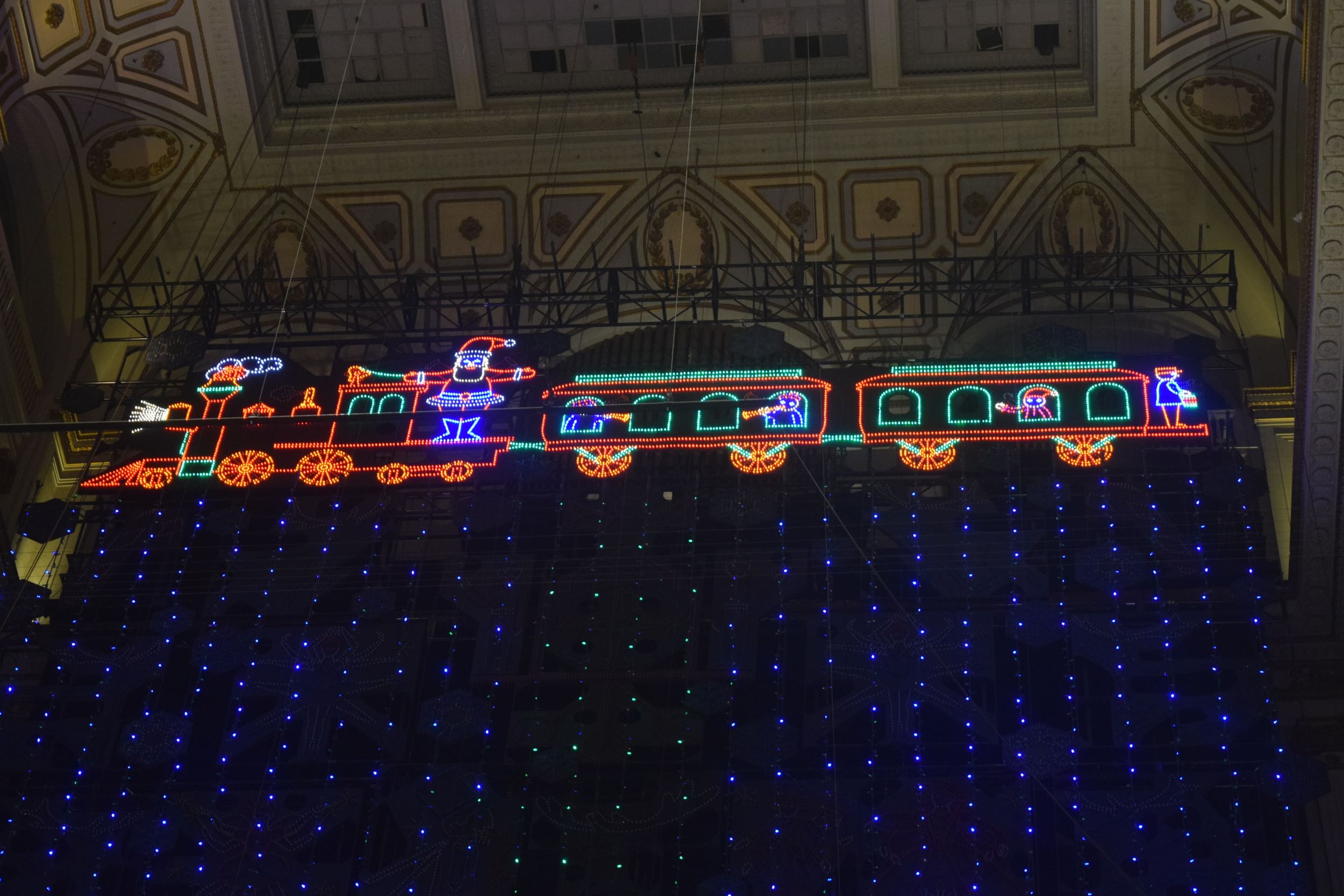View from below of the light show, showing a huge retro Christmas train in LED lights.