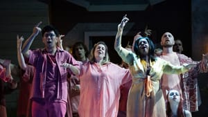 Lim, Newmon, and Heaston sing with arms raised in bright-colored flowing contemporary clothes, ensemble around them.