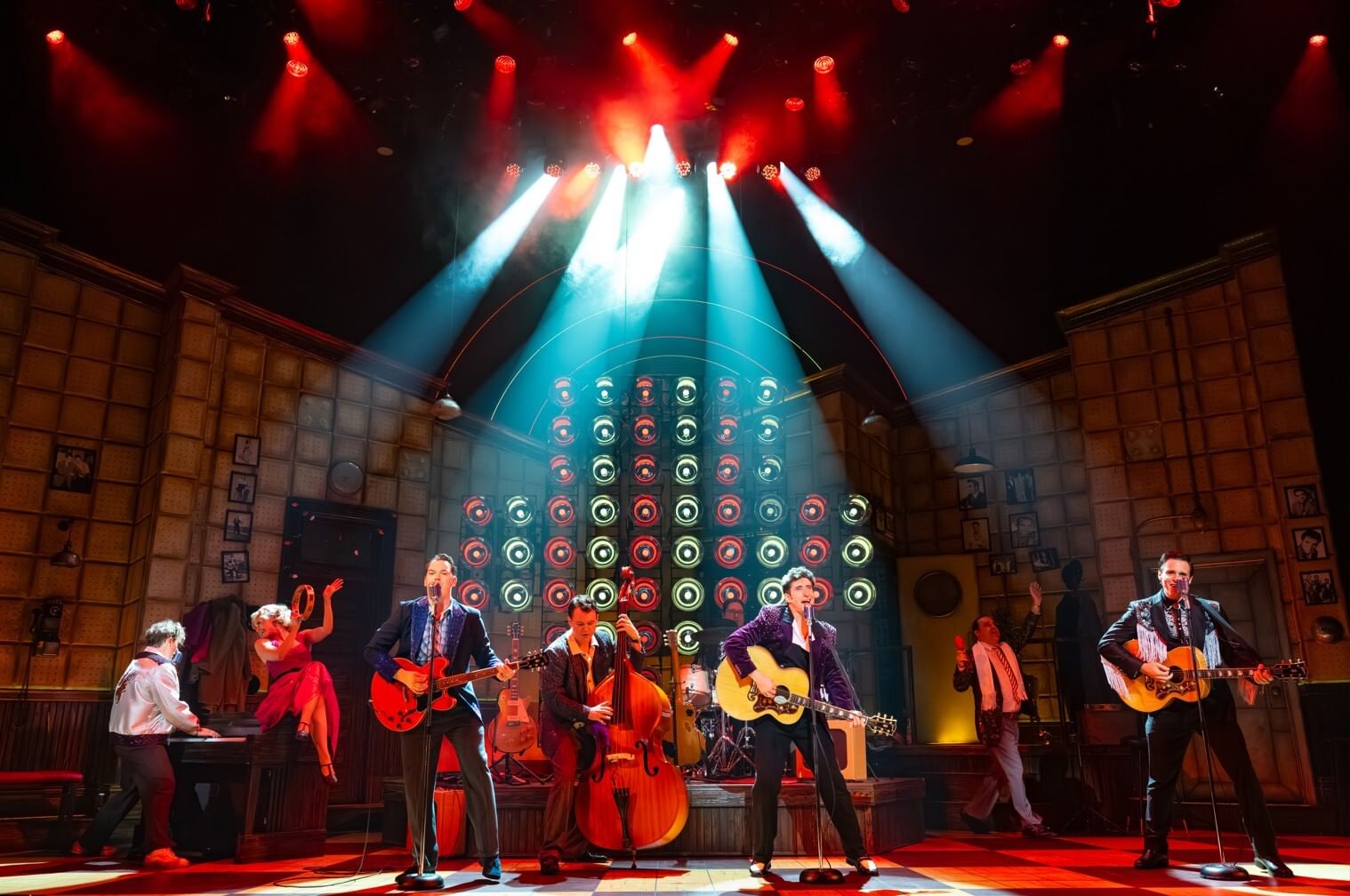 On a lavish music studio set with white & red spotlights, the whole cast rocks out with instruments, including guitar & piano