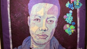 Sensitive head & shoulders quilt-like portrait of Tanisha, a Black woman, done in subdued purples, reds, and blues.