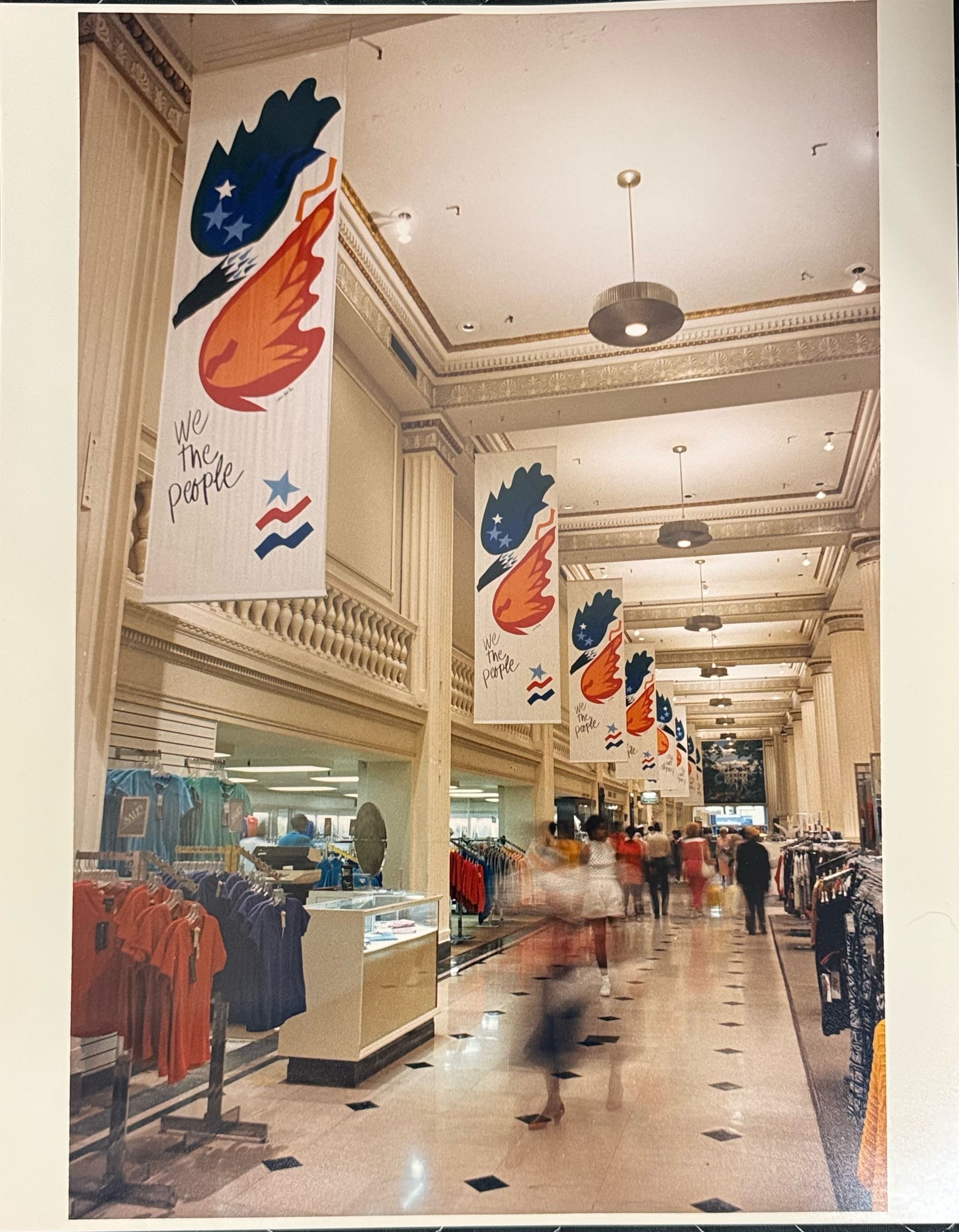 Ornate, high-ceilinged clothing store with Maitin’s banners in the corridor, featuring a blue & orange swooping eagle.