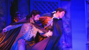 Figaro and Count Almaviva in colonial-style clothing and robes, in mid-song on stage.