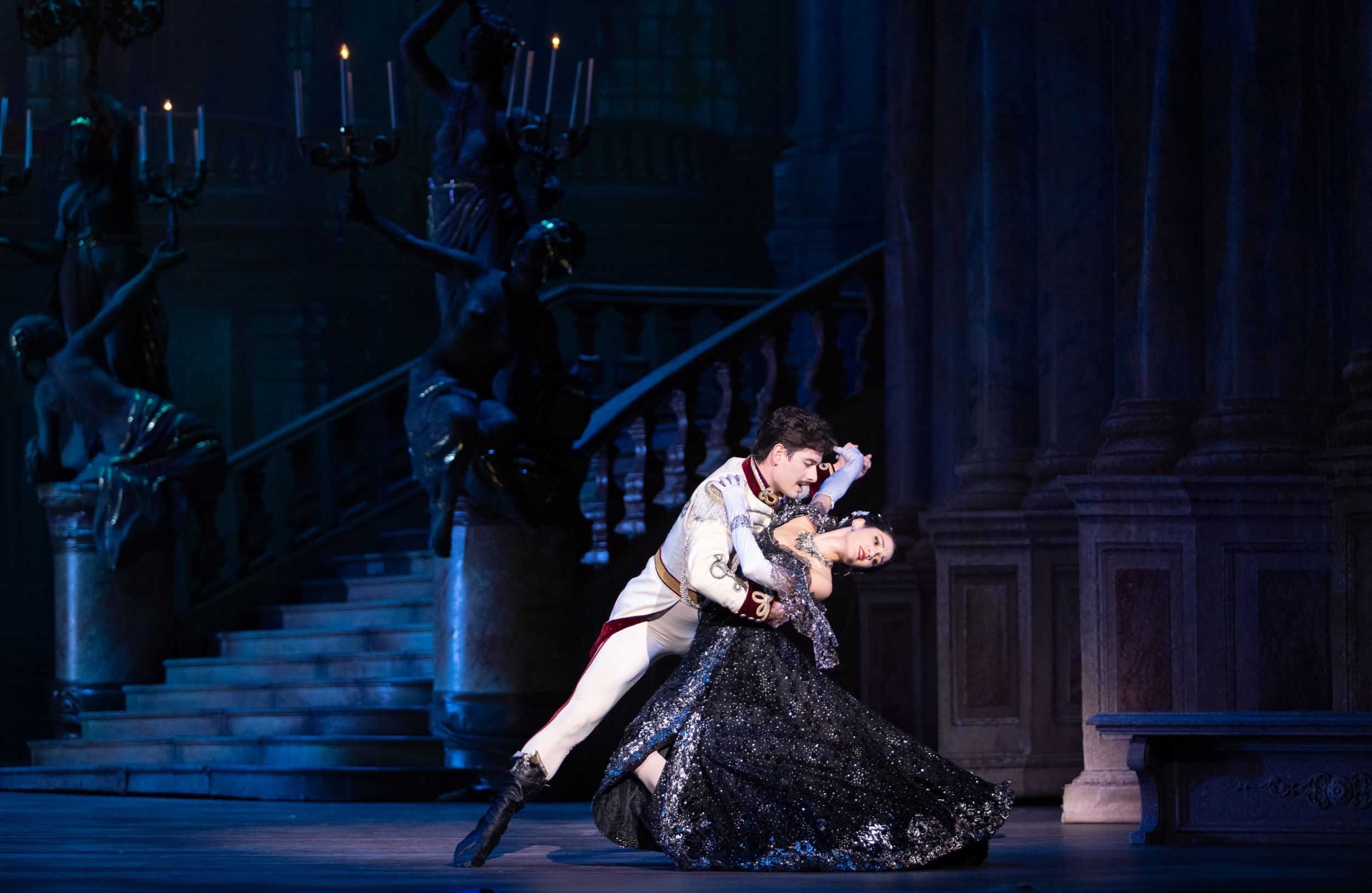 Pineiro, in a long sparkling black gown, partners with Baca, in princely white. He dips her passionately, one leg extended