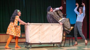 Canales, in flamboyant orange 60s garb, gleefully tips a leopard-printed Greer, scared by Peakes, into a canvas cart.