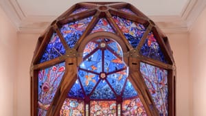 Graceful 8-foot indoor dome made of wood and minutely detailed stained glass in all colors, with an opening to enter.