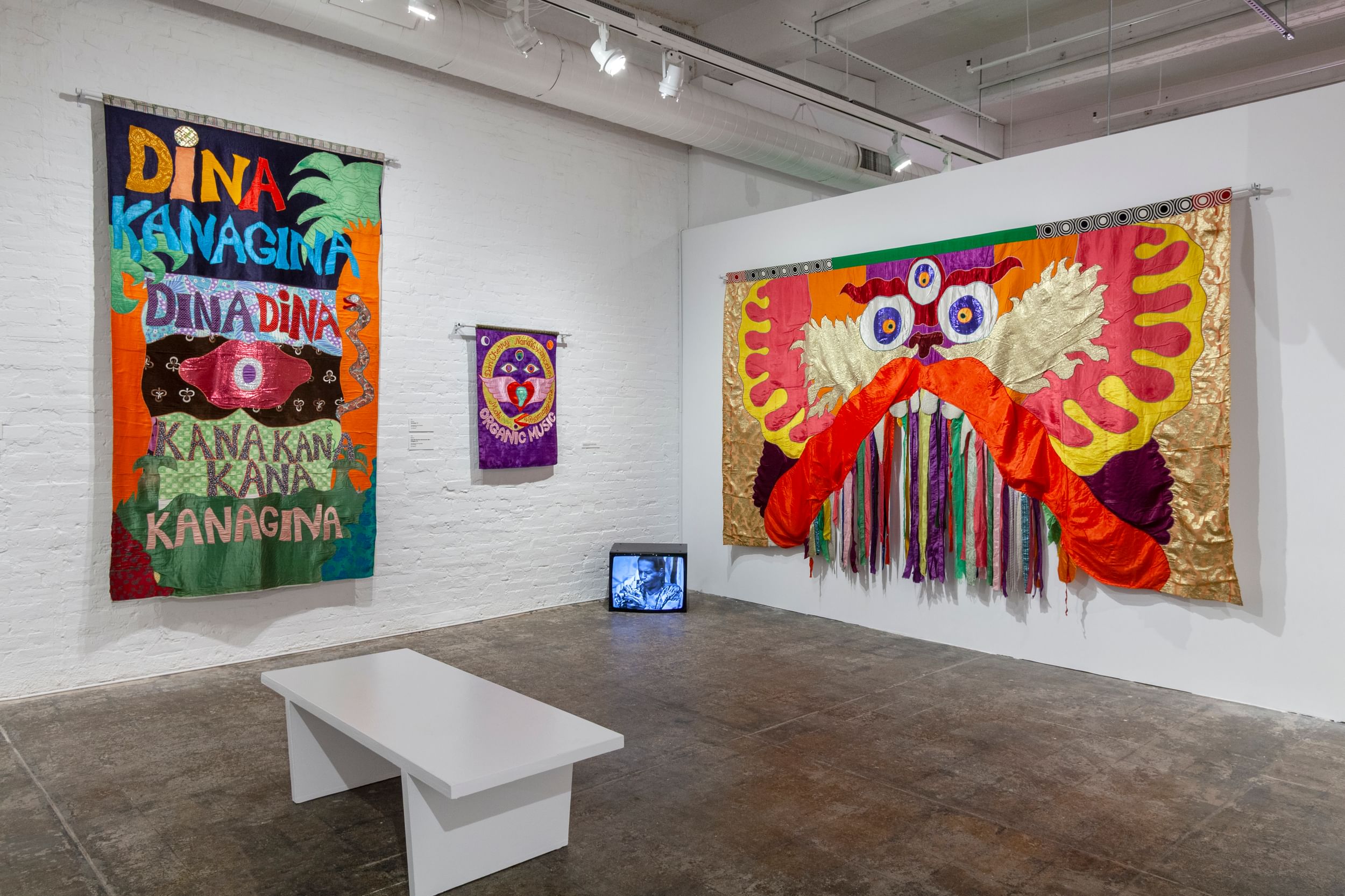 Three colorful Cherry banners on white walls, including a Chinese dragon in orange & yellow, ribbons hanging from its mouth.