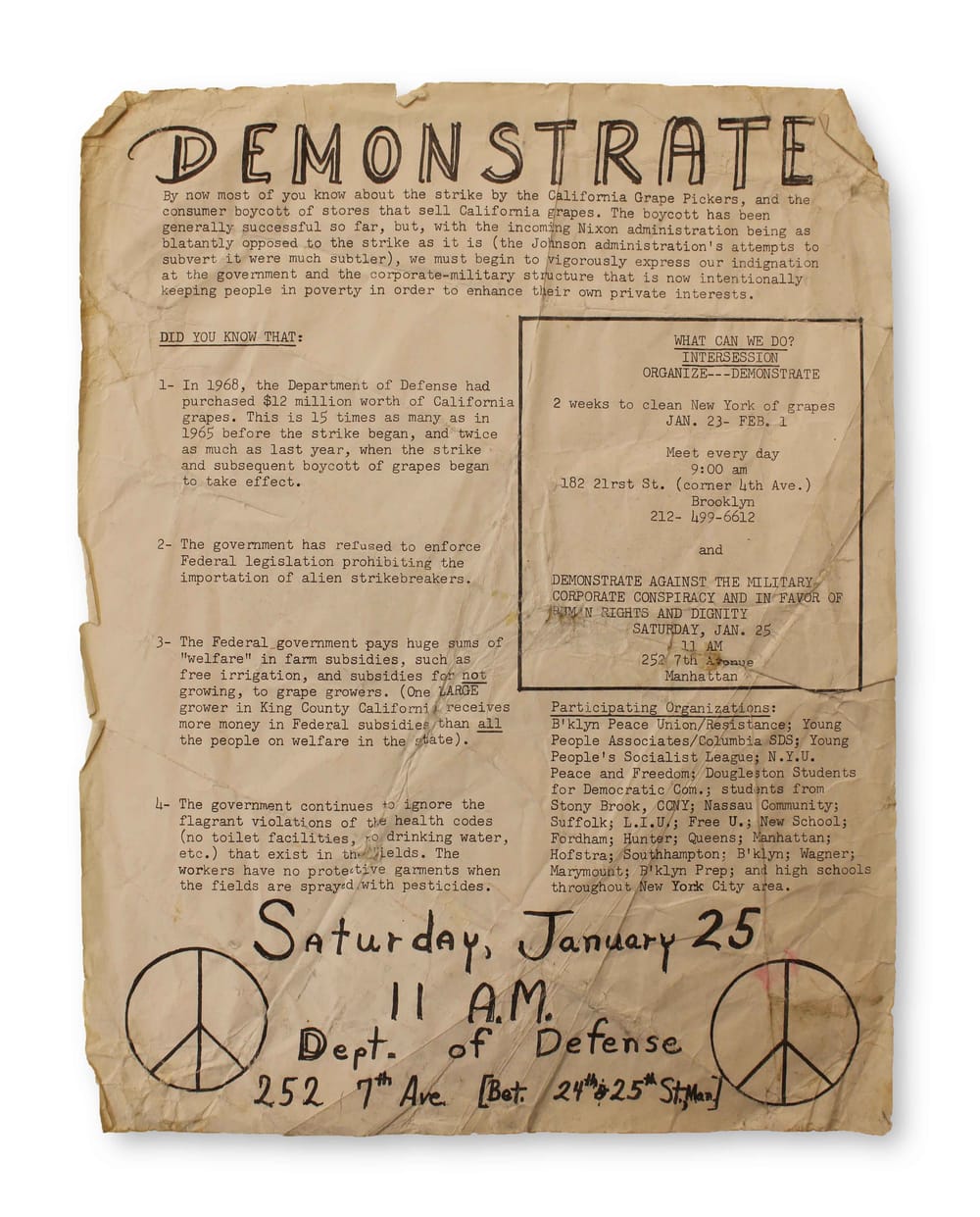 Yellowed original typed document with “demonstrate” written at top and location & time below in black, with peace signs.