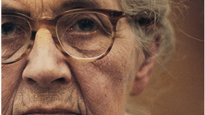 Book cover: title at top right in yellow and white text; superimposed on a close-up of Nadia’s serious face, late in life.