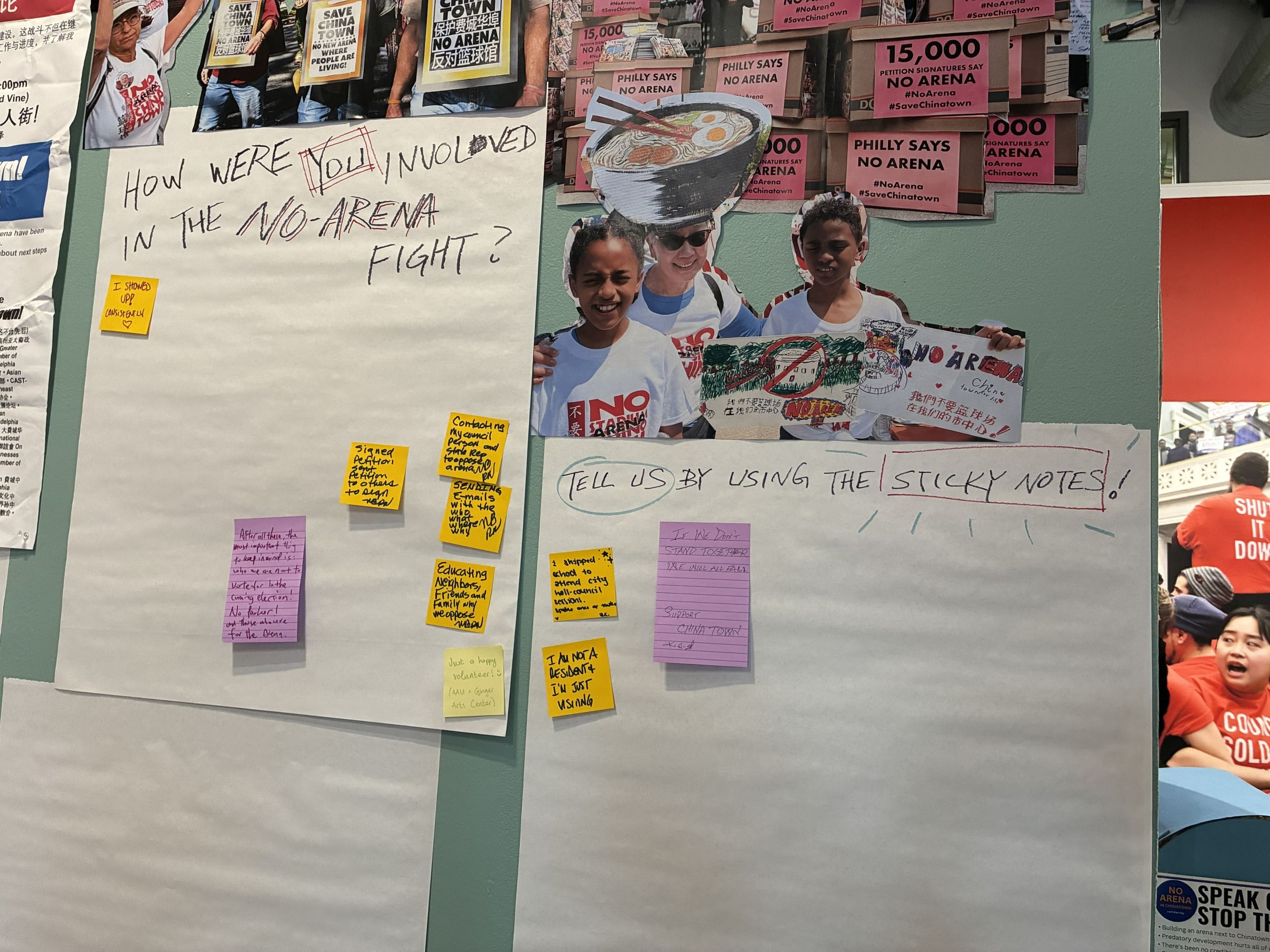 Beneath collages of protest photos, handwritten Post-Its are stuck to big pieces of paper asking “How were you involved?”