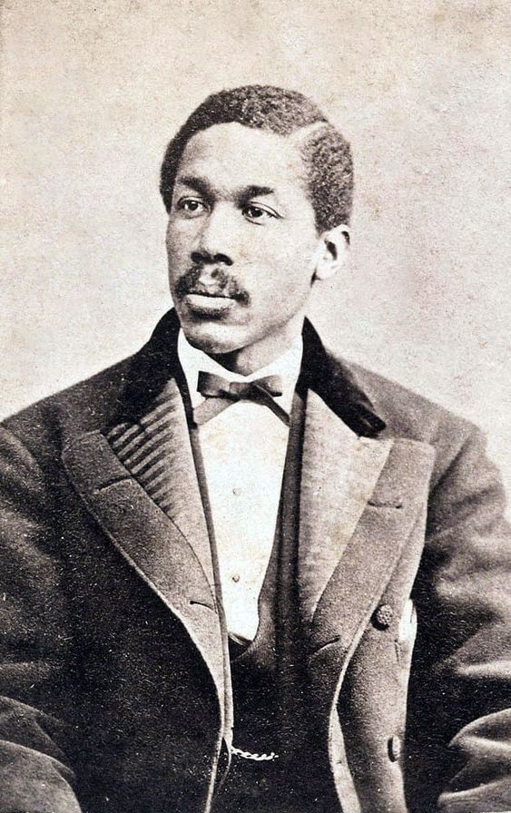 Historical black & white photo of Catto, a Black man with a mustache, looking to his right, wearing a dark formal suit.