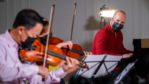 David Kim, Juliette Kang, and Yannick Nézet-Séguin perform in an Our City, Your Orchestra concert. (Photo by Jeff Fusco.)