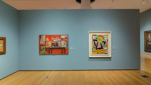 PAFA gallery view showing Marsden Hartley’s Flower Abstraction, and Raymond Saunders’s La Chambre, on a gray-blue wall.